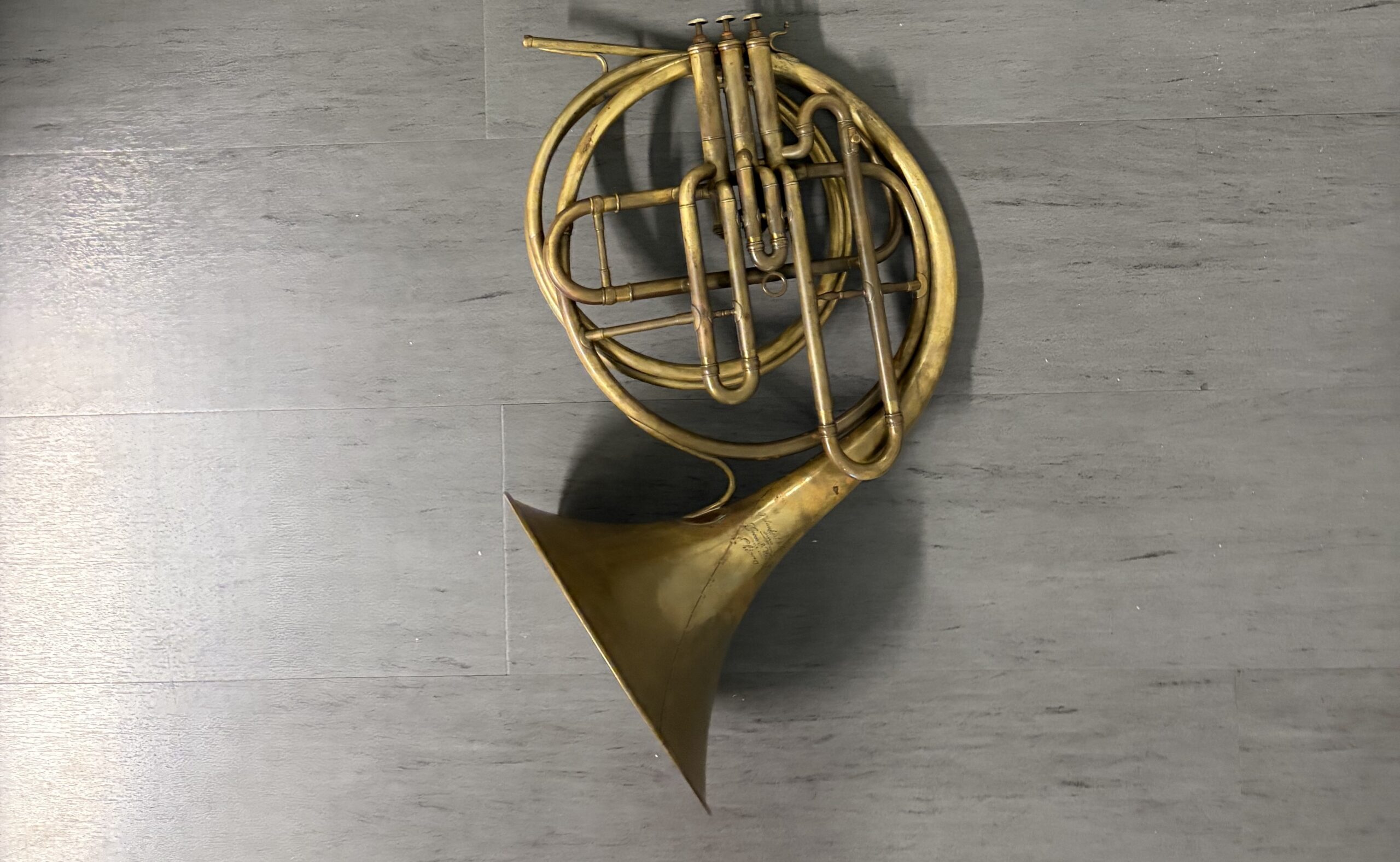 Eb french horn with long piston valves in raw brass