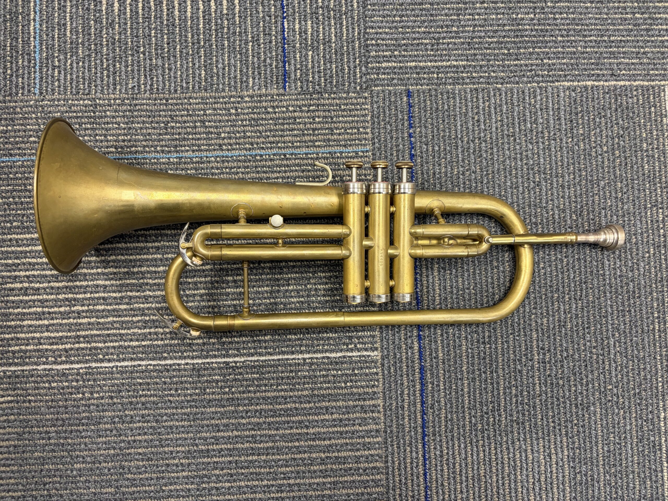 A brass trumpet made by Conn with three piston valves